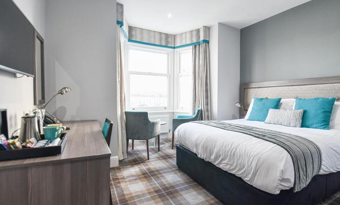 Boutique bedroom with sea view at the Belmont Hotel.